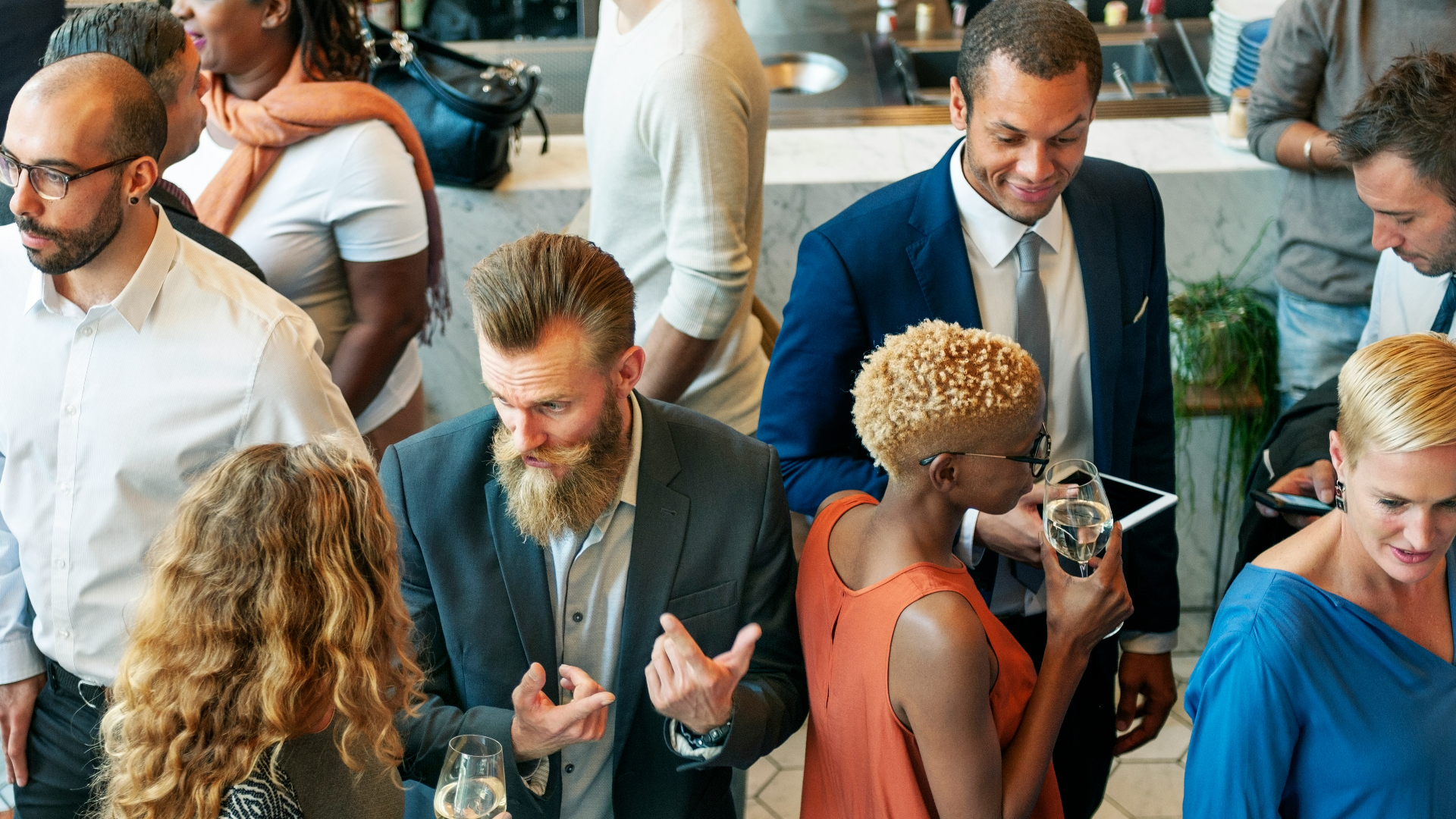 Professionals connecting in warm conversation at an industry gathering